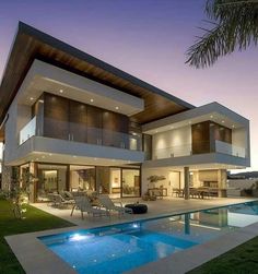 a modern house with a swimming pool in the front yard