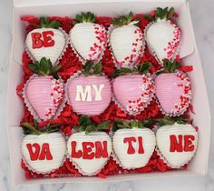 a box full of chocolate covered strawberries with the letters my and v on them