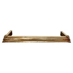 a gold shelf with two brackets on it's sides and one is holding something