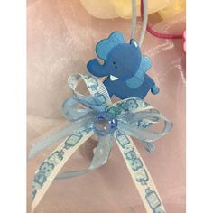 a blue teddy bear ornament hanging from a ribbon