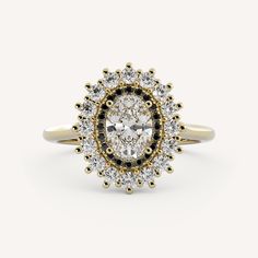 an oval shaped diamond ring with black and white diamonds in the center, surrounded by small round