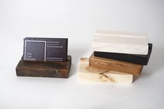 three wooden business cards sitting on top of each other