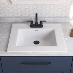 a white sink sitting on top of a counter next to a wooden cutting board and knife