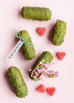 some kind of food that is on a pink surface with candy in the shape of hearts