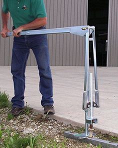 a man standing next to a metal pole with a wrench in it's hand