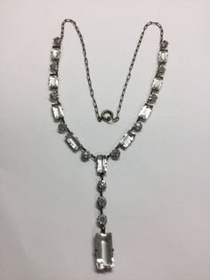 "This is a great representation of the Art Deco Era. It is a Sterling silver link chain with clear stones. I am not sure if the stones are glass of paste but they are in very nice shape, there is no yellowing to them. The main necklace is 16\" with the dangle being an additional 2\". Each stone is prong set and everything appears to be original. The spring ring is marked Sterling. If you pull the catch the whole way back it does seem to stick but just has to be pushed back to close. It weighs 8. Silver Link Chain, The Catch, Hand Ring, Rope Design, Clear Stone, Silver Art, Art Deco Era, Opal Pendants, Elegant Dress