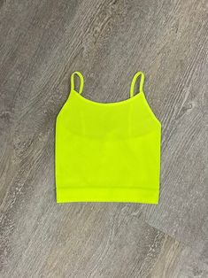 Our Power Pink Top is a seamless, ribbed cami style top. Available in sizes S/M & L/XL. 90% nylon 10% spandex available in hot pink, orchid, neon bubblegum, ocean blue, creamsicle, neon teal, and kelly green. Trendy Ribbed Stretch Camisole, Trendy Stretch Ribbed Camisole, Trendy Solid Color Spring Camisole, Trendy Solid Color Camisole For Spring, Summer Workout Camisole Tops, Trendy Ribbed Tops With Spaghetti Straps, Yellow Tank Top With Built-in Bra For Summer, Trendy Solid Color Summer Tank Top, Stretch Crop Top Tank In Solid Color