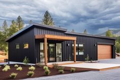 a black house with two garages on the front and one door open to let in lots of light