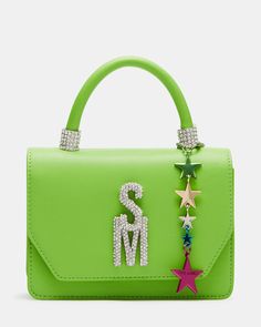 The BRAT mini bag features a top handle and a multi-colored star charm with bubble letter logo letters for a trendy look. With a crossbody strap and interior back wall, it offers convenience and organization while making a stylish statement. Structured mini top-handle bag Multi-colored star charm Rhinestone bubble logo letters Detachable crossbody strap Top handle: 3 inches Crossbody strap: 24 inches 5in H x 7in W x 3in D Synthetic materials Duster bag included Imported Trendy Top Handle Shoulder Bag With Logo, Green Top Handle Shoulder Bag With Logo, Bubble Logo, Mall Stores, Logo Letters, Bubble Letter, Mini Top, Bubble Letters, Synthetic Materials