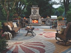 an outdoor patio with chairs, fire place and seating area in the middle of it