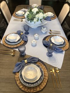 the table is set with blue and white dishes