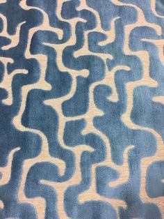 a blue and white rug with wavy lines on it