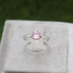 * Material: 925 Sterling Silver * DETAILS ✥ Handmade Ring ✥ - Center Stone: Lab Pink Sapphire  - Center Stone Size: 6 MM - Center Stone Shape: Round  - Side Stone: CZ diamond  ✥ O T H E R ∙ I N F O R M A T I ON ✥ ♦ Your item will be nicely packed to gift in elegant jewelry boxes. ♦ Custom Order We can make custom rings in almost any shape and style. If you want a specific model, please send us a clear picture and we will do our best. ♦ Delivery All Item will be Shipped within 3 to 5 Days after p Ponk Sapphire Ring Silver Small, Wedding Rings With Brilliant Cut Pink Sapphire, White Gold Pink Sapphire Ring For Wedding, Wedding Pink Sapphire Ring With Round Band, Pink Ruby Ring With Diamond Accents, Fine Jewelry Pink Ring With Center Stone, Elegant Pink Sterling Silver Diamond Ring, Pink Sapphire Birthstone Ring With Accent Stones For Wedding, Wedding Rings In Diamond White Pink Sapphire