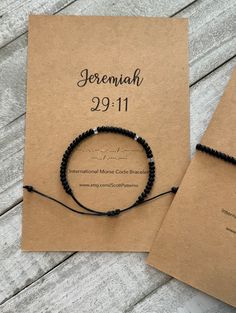 two bracelets on top of a brown card with the date and number 29 11