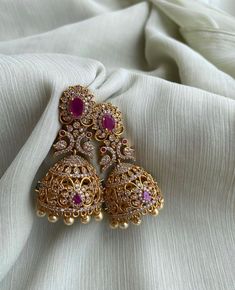 TEMPLE JHUMKA Kemp Ruby Stones Jhumka Earrings/Light weight /Antique Gold Finish/Indian Jewelry/desi jewelry / indian jhumkas Size : 3 inches approx  light weight  Elevate your style with these exquisite Temple Jhumka Earrings adorned with vibrant Kemp Ruby Stones and finished in antique gold. These Indian-inspired jhumkas are designed for both elegance and comfort, measuring approximately 3 inches in length and crafted to be delightfully lightweight. Embrace the timeless charm of desi jewelry with these stunning Indian jhumkas. Luxury Elegant Jhumkas For Reception, Luxury Kundan Jhumkas In Temple Jewelry Style, Luxury Bollywood Jhumkas With Stone Work, Luxury Chandbali Jhumkas For Diwali, Luxury Traditional Jhumkas For Wedding, Luxury Earrings For Eid Celebrations, Luxury Red Jhumkas For Wedding, Luxury Drop Bridal Earrings For Diwali, Luxury Bollywood Heavy Jhumkas