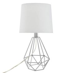 a table lamp with a white shade on the base and a cord attached to it