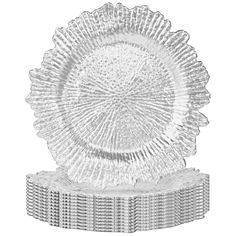 a clear glass plate sitting on top of a stack of white plastic plates and covers