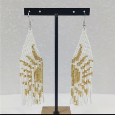 Bohemian Seed Bead Tassel White And Gold Sun Earrings Color: White And Gold That Form The Sun When Put Together New Without Tags In Excellent Condition White Beaded Fringe Festival Jewelry, Traditional White Beaded Fringe Jewelry, Festival White Beaded Fringe Jewelry, White Beaded Earrings For Summer, White Bohemian Beaded Dangle Earrings, White Bohemian Jewelry With Dangling Beads, White Fringe Tassel Earrings For Festivals, Gold Latkans Earrings For Beach, Gold Earrings With Latkans For The Beach