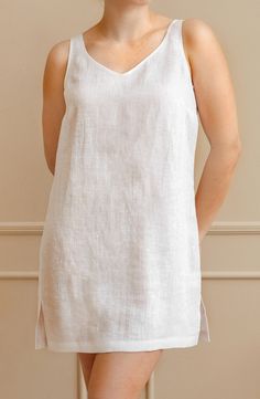 Elevate your summer wardrobe with our exquisite knee-length linen tunic. Crafted from lightweight and breathable linen fabric, this tunic offers the perfect combination of comfort and style. Whether you're strolling on the beach, exploring the city, or enjoying a casual outing, this versatile linen top is a must-have addition to your collection. Embrace the natural elegance of linen and indulge in the ultimate summer fashion.  ~ Includes 1 tunic; ~ OEKO-TEX Standard 100 certified fabric. * Pleas Linen V-neck Tunic For Daywear, Linen V-neck Tunic For Summer, Linen Sleeveless Dress For Loungewear, Linen Sleeveless Loungewear Dress, White Unlined Linen Dress, Unlined White Linen Dress, Summer Linen Tunic For Daywear, Summer Daywear Linen Tunic, Spring Linen Sleep Dress