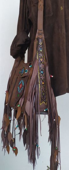 Native American inspired Handmade Leather Fringed Crossbody Bag.. Dark vintage brown Leather. Crossbody or Shoulder Bag depend your mood !! Beautiful Ethnic Handbag with Fringes and Beads. Painted with Native American Symbols-Desings- embroidered with nice colors! Both side of the Bag are Fringed and decoraded with beads-(you can ad your personal charms if you want). I enjoy every moment creating this exceptional Bag. Become better with hard use.Will take beautiful shades when aging. I wish that Hippy Party, Western Bags, Leather Fringe Handbag, Boho Leather Bags, Boho Chic Bags, Western Bag, Crossbody Leather Bag, Leather Fringe Bag, Western Handbags