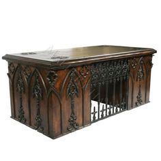 an old wooden desk with ornate carvings on the front and sides, sitting against a white background