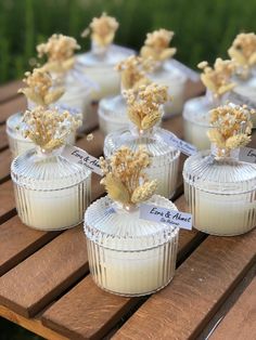 small white cupcakes sitting on top of a wooden table