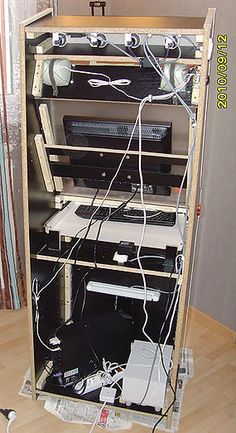 a computer tower with several computers and cords