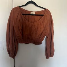 Universal Thread Cropped Blouse Size Large. Color Is A Burnt Orange. Never Worn. Brown Long Sleeve Cotton Blouse, Chic Long Sleeve Crop Top With Relaxed Fit, Brown Cotton Long Sleeve Blouse, Long Sleeve Brown Cotton Blouse, Long Sleeve Cotton Blouse In Brown, Casual Brown Cotton Blouse For Fall, Brown Cotton V-neck Blouse, Chic Fall Cotton Peasant Top, Chic Brown Tops For Daywear