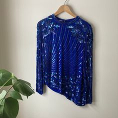 "Gorgeous asymmetrical blouse in royal blue silk and iridescent sequins. Excellent vintage condition! Extra long back zipper for easy wear, fully lined. Tag reads Scala, Milano Paris, made in India. length 23/27\" chest 17\"  shoulder 16\" sleeve 24\" shoulder to cuff Thanks for stopping by and feel free to ask any questions!" Blue Silk Blouse, Asymmetrical Blouse, Blue Silk, Easy Wear, Silk Blouse, Extra Long, Womens Clothing Tops, Royal Blue, Blouses For Women