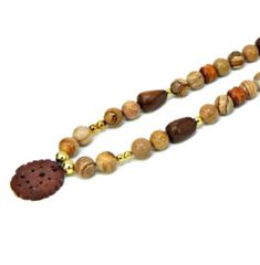 48.00 USD Jasper Beaded Necklace, Tan and Brown Natural Stone and Wood Bead Medallion Necklace, Bead Chinese Pendant Necklace, Vintage Jewelry Presented by EclecticVintager This chic boho style vintage necklace is made up of natural polished river rock tumbled stones in tan and brown tones with wooden beads in various shapes. The stones being natural has varying inclusions and marbling. The stone bead necklace has an Asian style medallion pendant. Gold tone metals bead are used for separators… Bead Medallion, Chinese Pendant, Stone And Wood, Pendant Necklace Vintage, Jasper Jewelry, Necklace Bead, Enamel Bangle, Stone Beaded Necklace, Butterfly Pendant Necklace