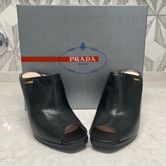 Brand New, Never Worn Prada Black Leather Clog Gold Hardware Original Box And Dust Bag Included Heel Height : 4.25” Black Calf Leather Mules With Open Heel, Black Calf Leather Open Heel Mules, Elegant Leather Clogs With Padded Heel, Open Toe Clogs With Reinforced Heel For Formal Occasions, Chic Formal Clogs With Reinforced Heel, Formal Open Toe Clogs With Reinforced Heel, Chic Leather Clogs For Formal Occasions, Luxury Formal Clogs With Open Heel, Chic Formal Leather Clogs