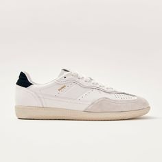 White leather sneakers with black heel tabs Trimmed with suede across the toes, the Tb.490 sneaker nods to traditional track shoes. It comes in a low-top silhouette set on flat rubber soles and finished with extra details, such as logo stamps and black heel tabs for contrast.