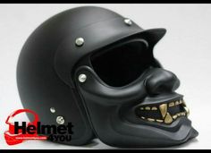 a black helmet with gold teeth on it