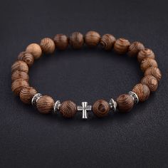 Wood Bracelet with Cross Christian Bead Wristlet Material: Wood Bead Size: 8mm Bracelet Length: 6.5-7.5 inches Made in the USA – Premium Quality - Better Customer Service from (USA) – Environmentally Friendly - Will Not Cause Allergic or Skin Reactions (100% Safe to Wear at All Times for Kids and Adults) D E S I G N • B E N E F I T S Rest assured the wood bracelet with cross you receive will be in perfect condition as it is inspected before labeling as “perfect to sell”. This wood bracelet's sty Mens Vintage Jewelry, Cross Bracelets, Prayer Bead Bracelet, Shark Earrings, Compass Bracelet, Meditation Prayer, Wood Bead Bracelet, Hook Bracelet, Surfer Necklace