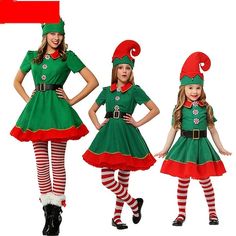 three girls dressed up in christmas costumes, one is wearing a santa hat and the other has a green dress with red stripes