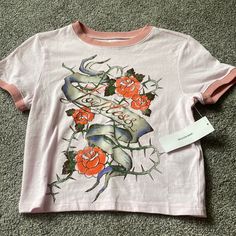 Size Large Graphic Rose Design Baby Tee From Urban Outfitters. Brand New With Tags Summer Graphic Tee With Rose Print, Trendy Rose Print T-shirt For Spring, Cotton Crew Neck Top With Rose Print, Cotton Graphic Tee With Rose Print, Spring Cotton T-shirt With Rose Print, Spring Graphic Tee With Rose Print, Short Sleeve Rose Print Graphic Tee Tops, Spring Rose Print Graphic Tee, Pink Rose Print T-shirt For Summer