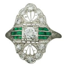 Art Deco 1920's Platinum Diamond Ring with Green Stones .55 carats One Round Brilliant Cut Diamond weighing .25 carats approximately [GH VVS-VS1] Ten Round Cut Diamonds weighing .30 carats approximately [GH VVS-VS1] Twelve Fancy Cut Green Stones. Glass or Better. Beautiful Filigree and Engraving. Ring Size 6 1/2 Art Deco Oval Emerald Ring With Brilliant Cut, Art Deco Brilliant Cut Diamond Ring Collectible, Art Deco Collectible Diamond Ring With Brilliant Cut, Art Deco Diamond Cluster Ring With 17 Jewels, Art Deco Diamond White Ring With 17 Jewels, Vintage Emerald Ring With Vvs Diamond, Art Deco Diamond Ring With 17 Jewels, Art Deco Diamond Rings With 17 Jewels, Vintage Green Diamond Platinum Ring