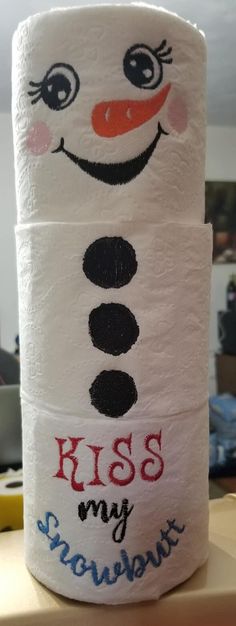 a toilet paper roll with the words kiss my snowman on it and a smiling face