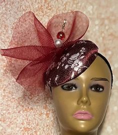 Burgundy Fascinator Hat accented with hat pin. Perfect for church, weddings, funerals and special occasions. Hat measures approximately 5.9 inches in diameter. The hat affixes to the head by a hat elastic. Love what you see, but would like it in a different color, shape or size? Please contact us by sending a message. We offer custom hats in a variety of styles. PLEASE NOTE All items for Free Shipping will be shipped via USPS First Class Mail. Gifts for mom, sister, wife, or yourself. Handmade Fitted Hats For Formal Occasions, Handmade Fitted Formal Hats, Formal Fitted Handmade Hats, Handmade Formal Hats, Handmade Adjustable Formal Hats, Party Mini Hat With Adjustable Curved Brim, Adjustable Mini Hats With Curved Brim For Party, Elegant Adjustable Fascinator As A Gift, Adjustable Mini Hat With Curved Brim For Parties