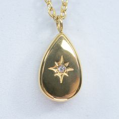 elevate your style with our tears of gold necklace. featuring a beautiful starburst set in a bold teardrop pendant, this piece radiates elegance and charm. the ideal add-on to elevate your layered look and make you shine like the star you are. 18k gold pvd over 316L stainless steel water resistant cz center accent teardrop pendant is 14mm long x 9mm wide and 4mm thick chain is 1mm thick 16" long + 2" extender Gold Teardrop Pendant Drop Necklace Tarnish Resistant, Tarnish Resistant Teardrop Pendant Charm Necklace In Yellow Gold, Gold Teardrop Charm Necklace For Everyday, Everyday Gold Teardrop Charm Necklace, Gold Teardrop Charm Necklaces Tarnish Resistant, Gold Teardrop Tarnish Resistant Charm Necklaces, Gold Teardrop Charm Necklace Tarnish Resistant, Gold Teardrop Necklace With Detachable Pendant, Tears Of Gold