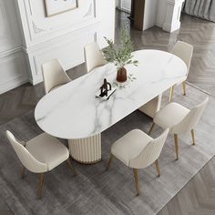 a white marble dining table surrounded by beige chairs and an area rug in the middle