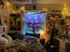 a bedroom with lights and posters on the wall