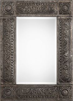 an ornate silver framed mirror on a white background