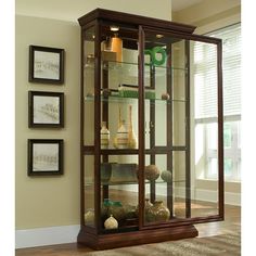 a display case with glass doors in a living room