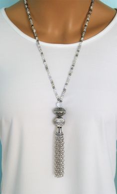 "Four different styles of silver beaded tassel necklaces to choose from, designed and handmade by Ralston Originals. I made all the tassels with silver chains, and covered each in a beautiful antique silver metal bead cap. The first beaded necklace (Pictures 1-3), is made with a very unique and beautiful large silver bead, with many tiny crystal inlaid accents. The necklace is also made with a large antique silver crystal roundel, and a large clear crystal bead. The beaded chain on the necklace Luxury Single Strand Beaded Necklaces As Gift, Luxury Long Single Strand Beaded Necklace, Luxury Traditional Sterling Silver Beaded Necklace, Cheap Long Beaded Necklace With Round Beads, Handmade Silver Long Tassel Necklace, Silver Bohemian Lariat Tassel Necklace, Adjustable White Tassel Necklace, Adjustable Beaded Chain Tassel Necklace As Gift, Adjustable Beaded Tassel Necklace With Dangle