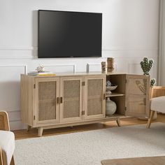 an entertainment center with wicker doors in a living room