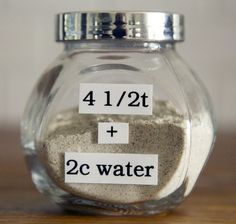 a glass jar filled with lots of sand on top of a wooden table