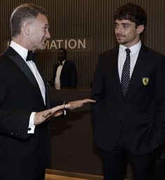 two men in suits talking to each other