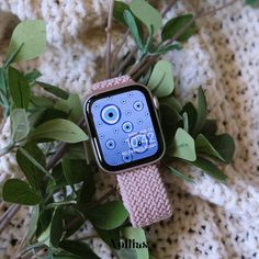 an apple watch sitting on top of a plant