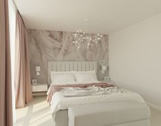 a white bed sitting next to a window in a bedroom under a chandelier